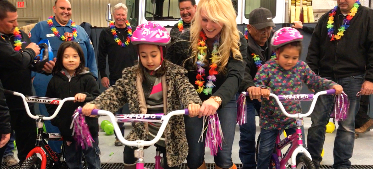 bike build team building event image with people donating bike to happy recipients